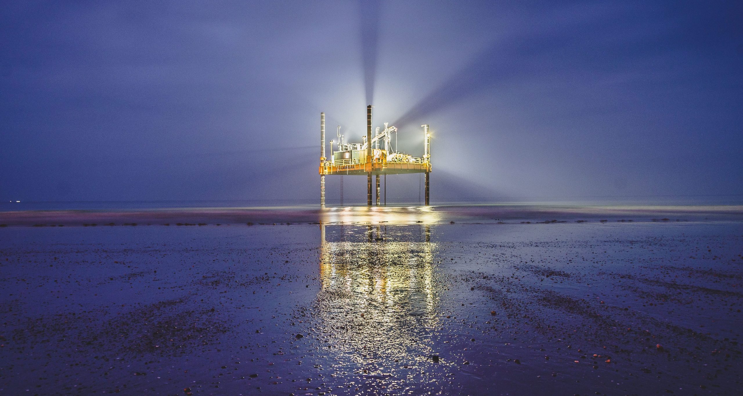 modular jack up barge in surf area at night